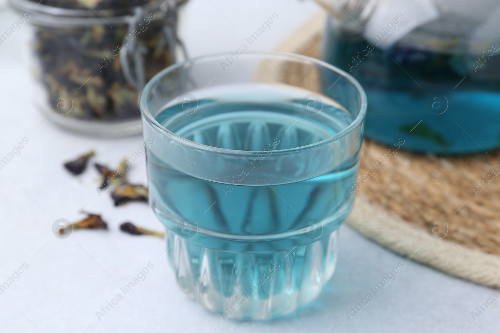 Photo of Delicious butterfly pea flower tea on light table, closeup