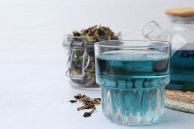 Delicious butterfly pea flower tea on light table. Space for text