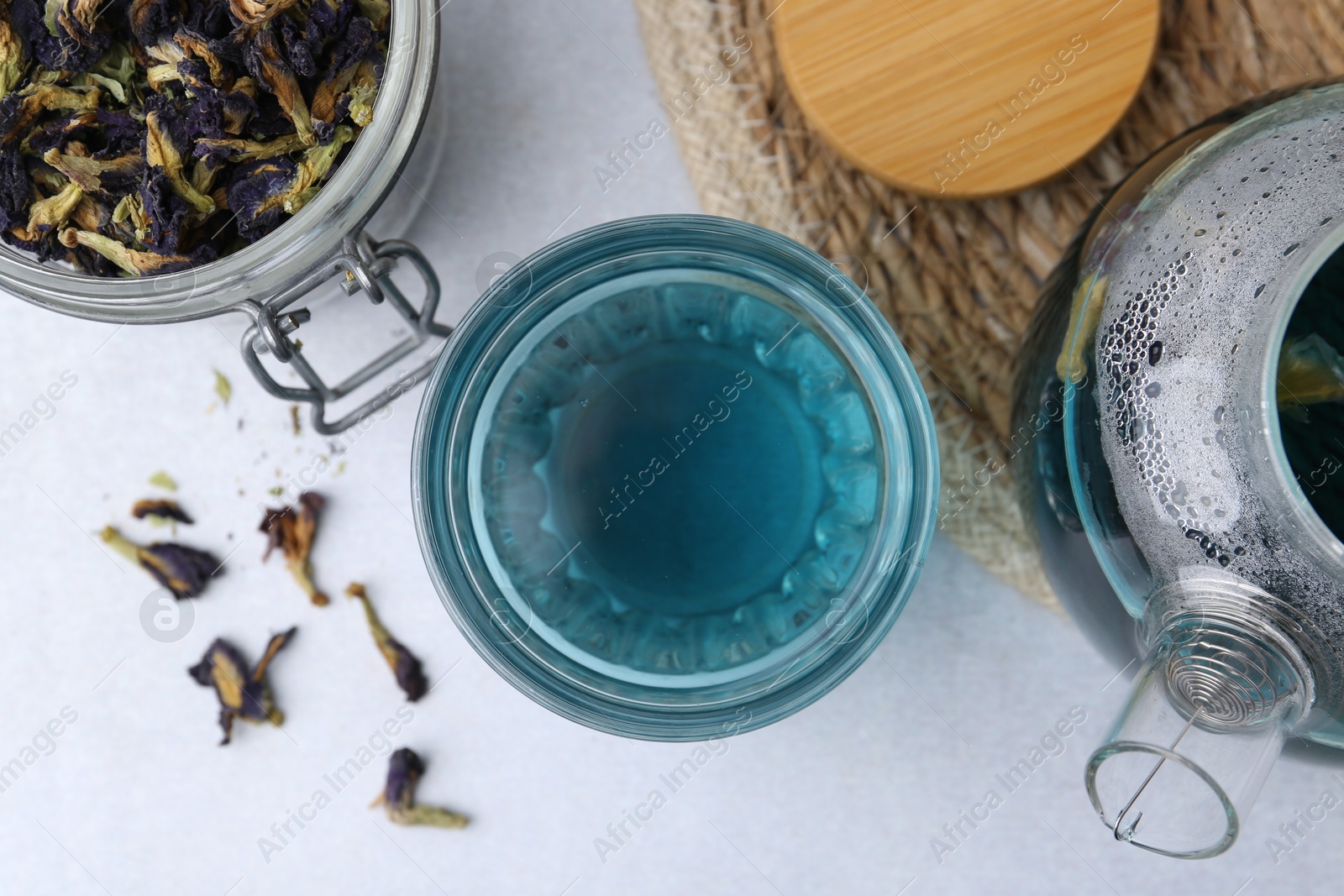 Photo of Delicious butterfly pea flower tea on light table, flat lay