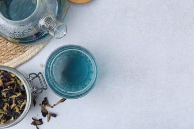 Photo of Delicious butterfly pea flower tea on light table, flat lay. Space for text