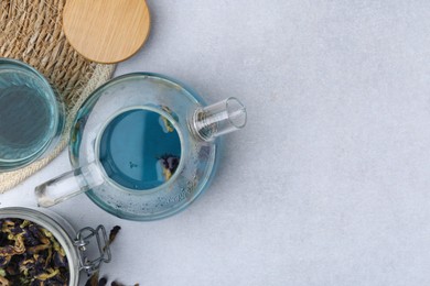 Delicious butterfly pea flower tea on light table, flat lay. Space for text