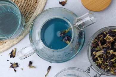 Photo of Delicious butterfly pea flower tea on light table, flat lay