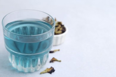 Delicious butterfly pea flower tea on light table, closeup. Space for text