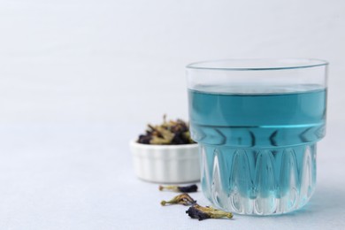 Delicious butterfly pea flower tea on light table. Space for text