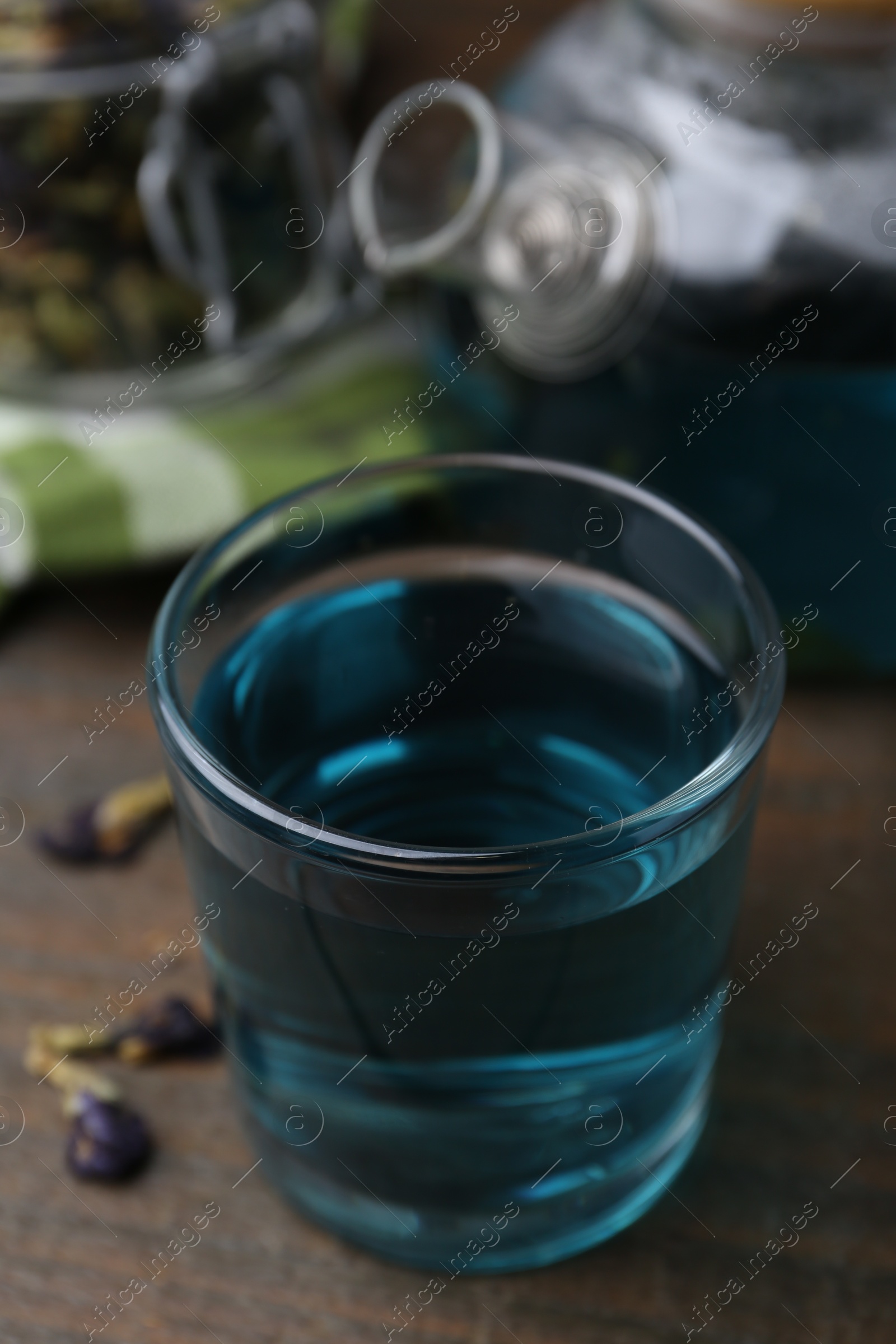 Photo of Delicious butterfly pea flower tea on wooden table, closeup