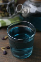 Delicious butterfly pea flower tea on wooden table, closeup