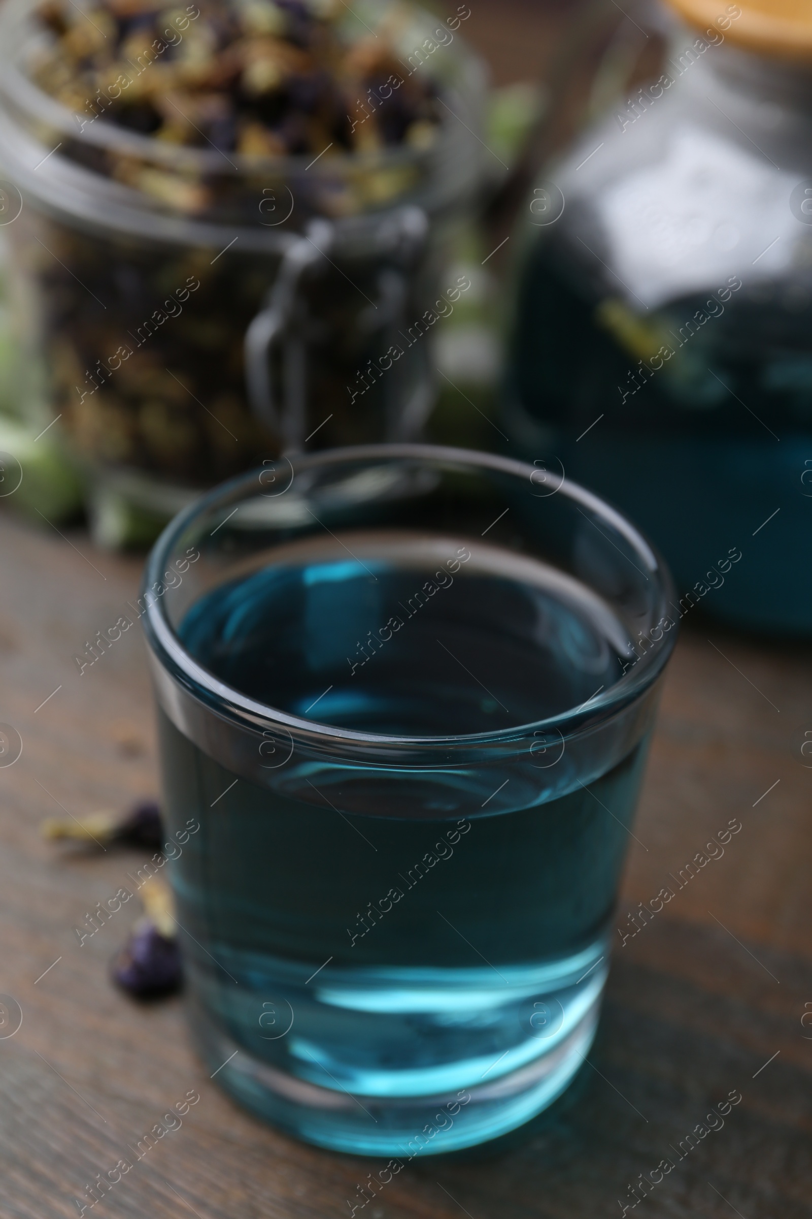 Photo of Delicious butterfly pea flower tea on wooden table, closeup