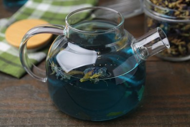 Delicious butterfly pea flower tea on wooden table, closeup