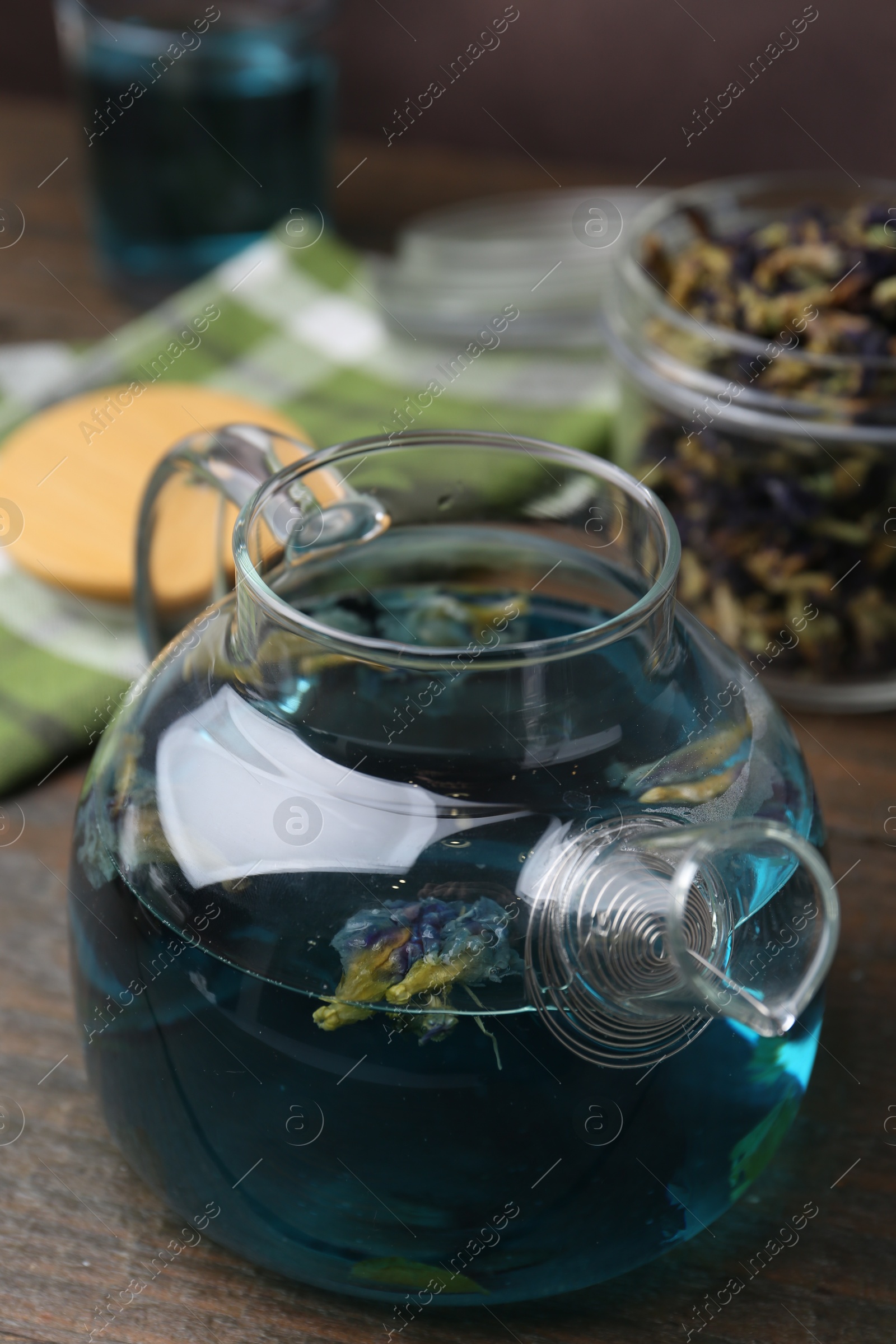 Photo of Delicious butterfly pea flower tea on wooden table, closeup