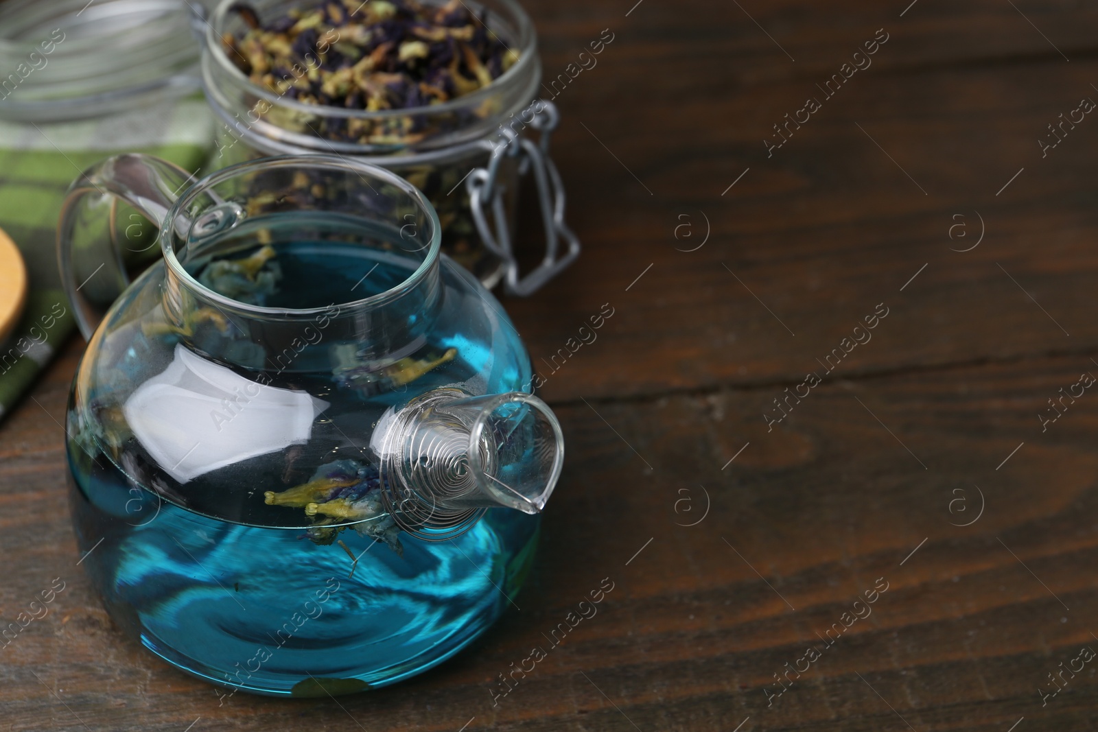 Photo of Delicious butterfly pea flower tea on wooden table. Space for text