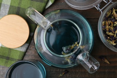 Photo of Delicious butterfly pea flower tea on wooden table, flat lay