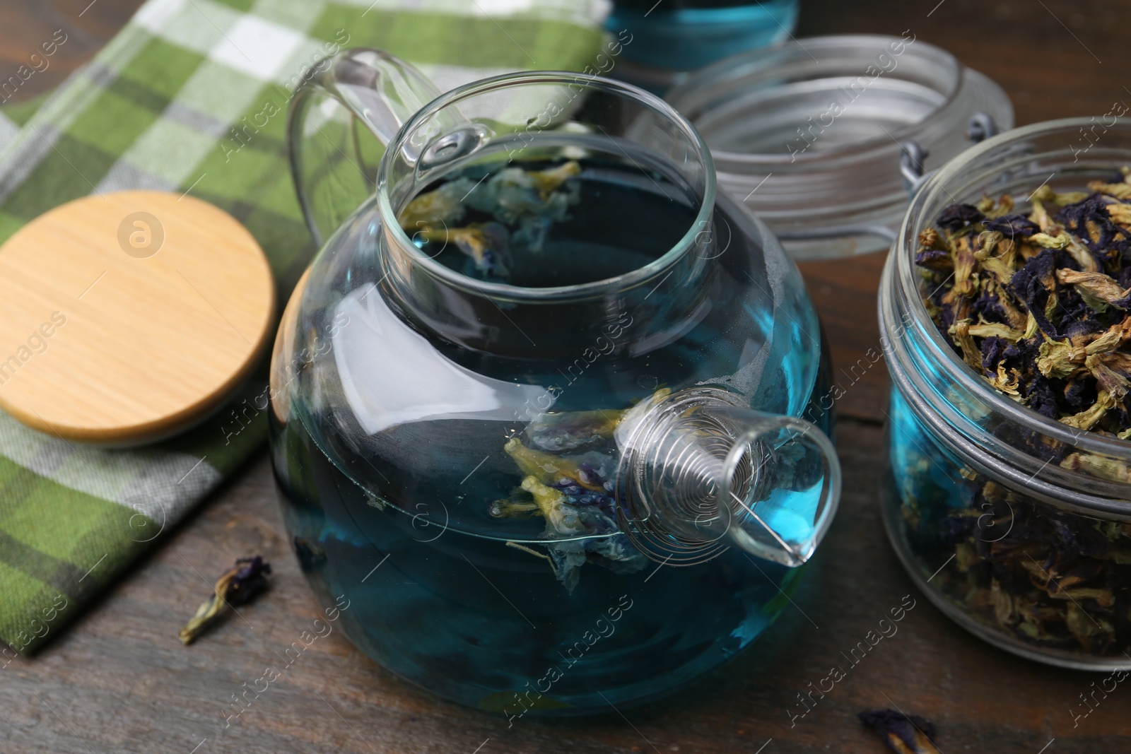 Photo of Delicious butterfly pea flower tea on wooden table, closeup