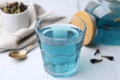 Delicious butterfly pea flower tea on white table, closeup