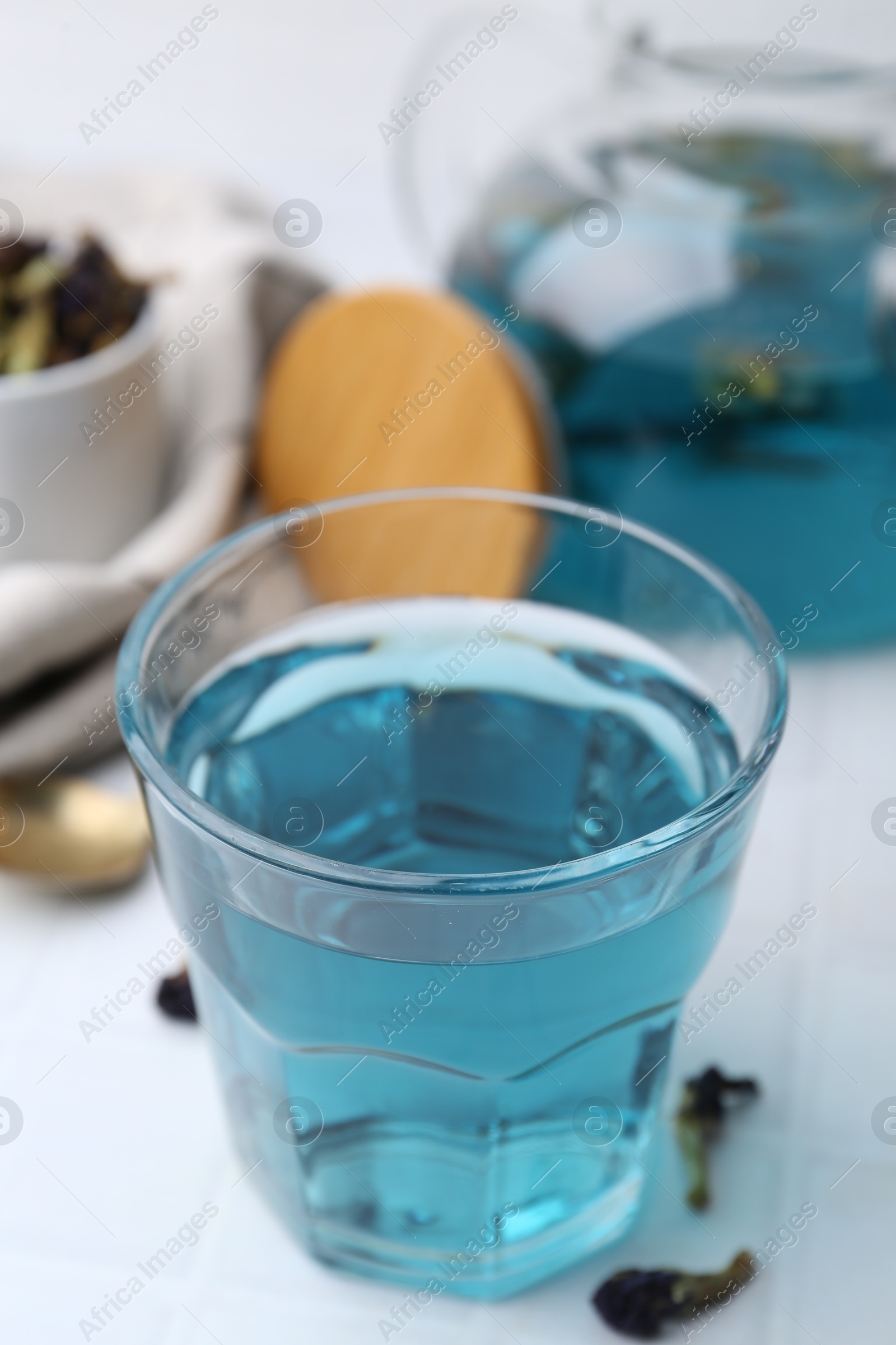 Photo of Delicious butterfly pea flower tea on white table, closeup