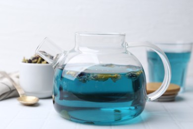 Photo of Delicious butterfly pea flower tea on white tiled table