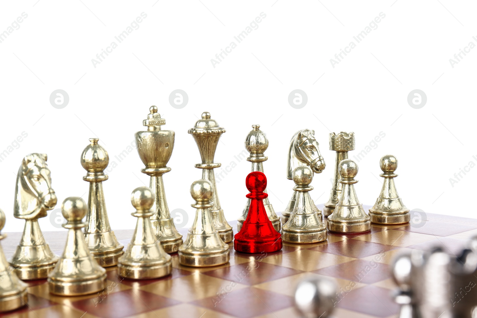 Image of One red pawn among golden chess pieces on wooden chessboard