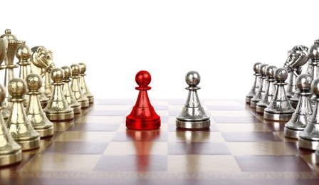 Image of Red pawn standing in front on silver one on wooden chessboard