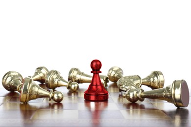 Image of Red pawn standing among lying chess pieces on wooden chessboard