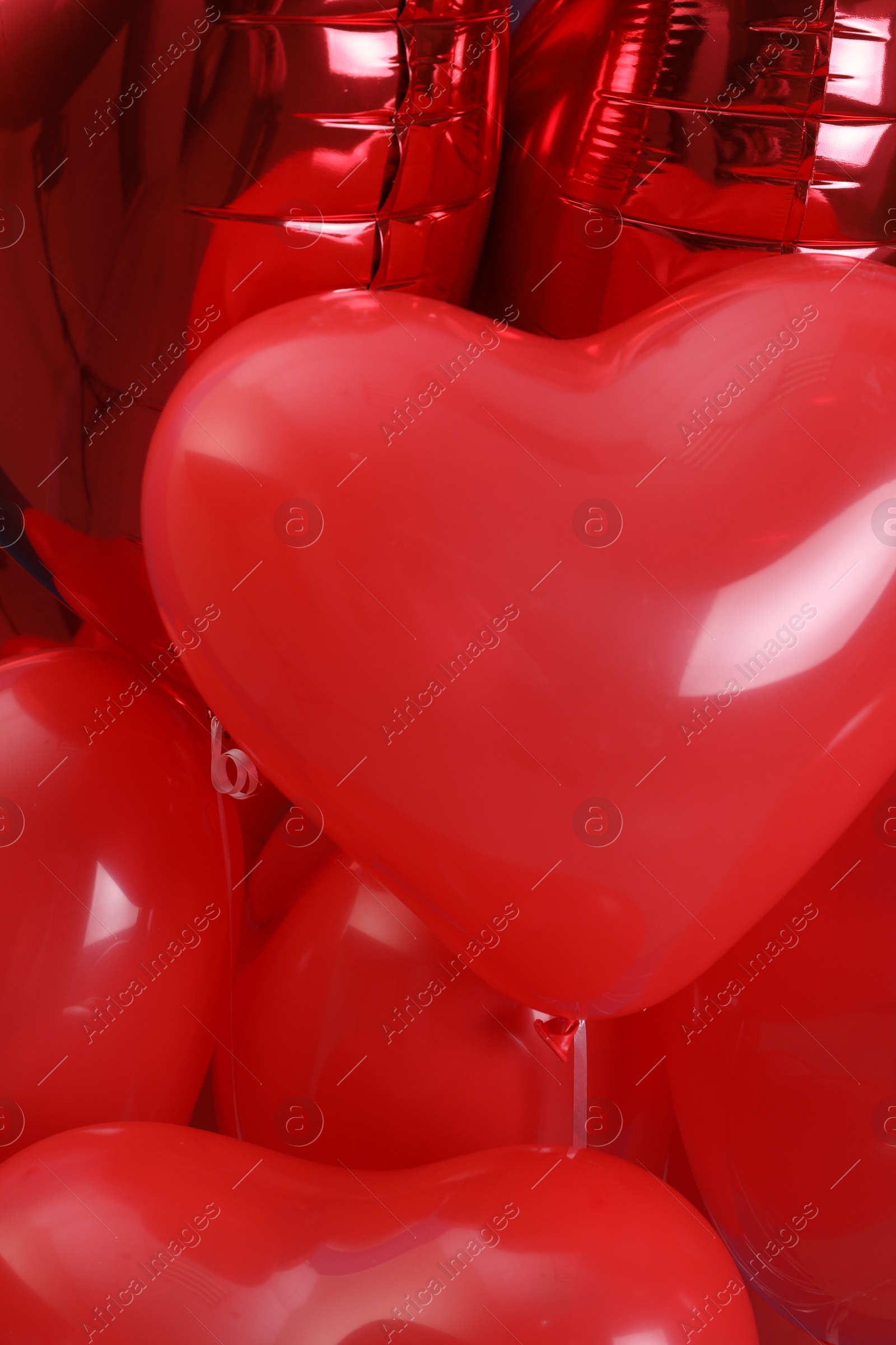 Photo of Red heart shaped balloons as background, closeup. Valentine's day celebration