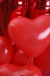 Photo of Red heart shaped balloons as background, closeup. Valentine's day celebration