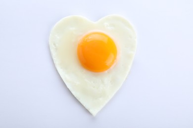 Photo of Heart shaped fried egg isolated on white, top view