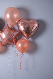 Photo of Different balloons near light wall. Festive decor