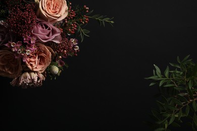 Photo of Beautiful fresh flowers on black background, space for text