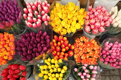 Photo of Assortment of bright flowers in shop, above view. Floral decor