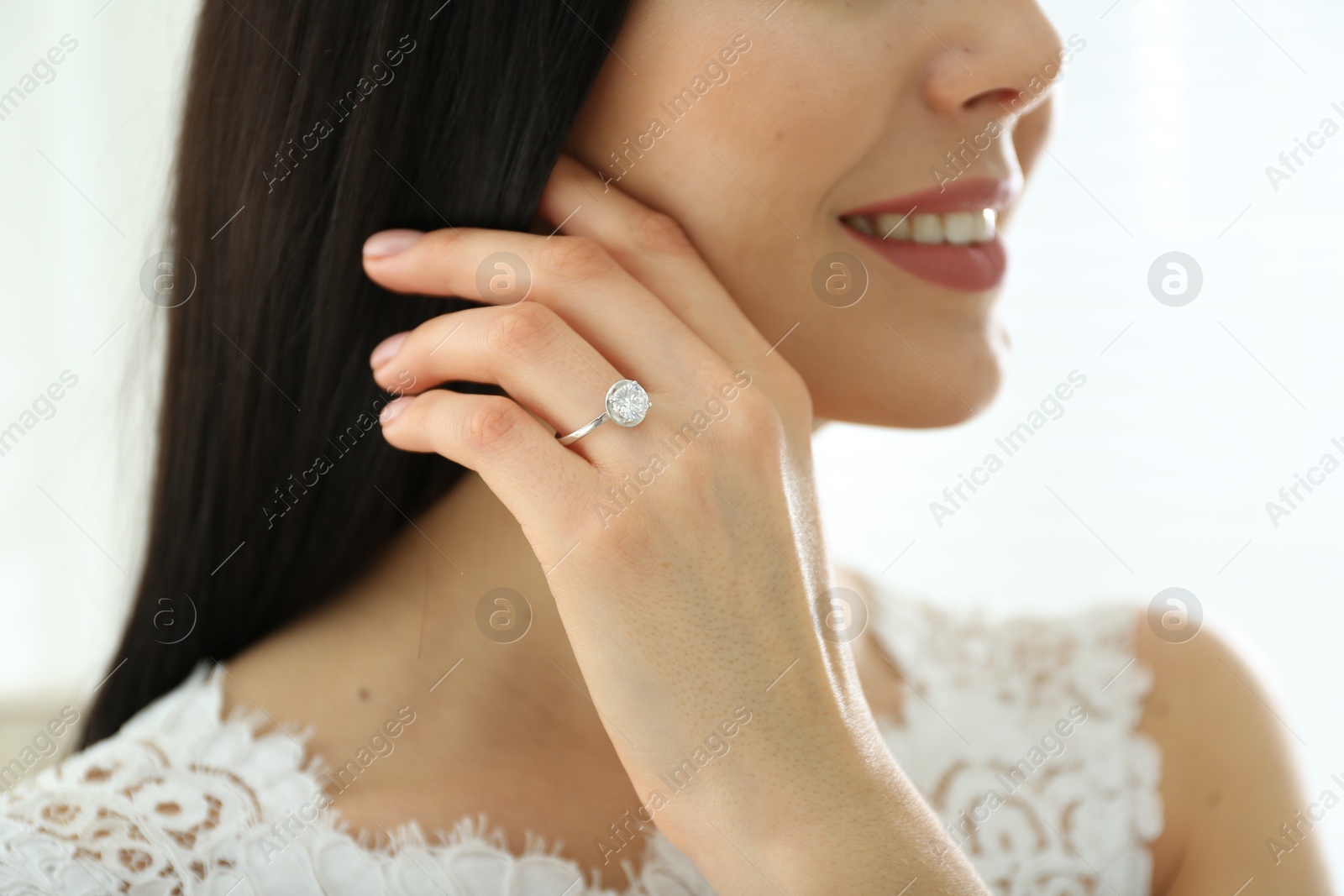 Photo of Young bride wearing beautiful engagement ring, closeup