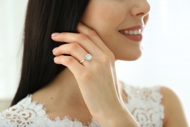 Young bride wearing beautiful engagement ring, closeup