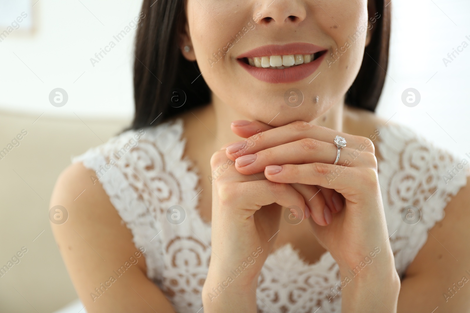 Photo of Young bride wearing beautiful engagement ring, closeup