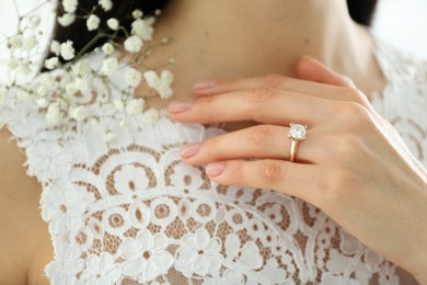 Photo of Young bride wearing beautiful engagement ring, closeup