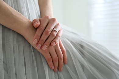 Photo of Young bride wearing beautiful engagement ring, closeup