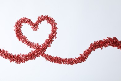 Photo of Heart made of bright sprinkles on white background, top view