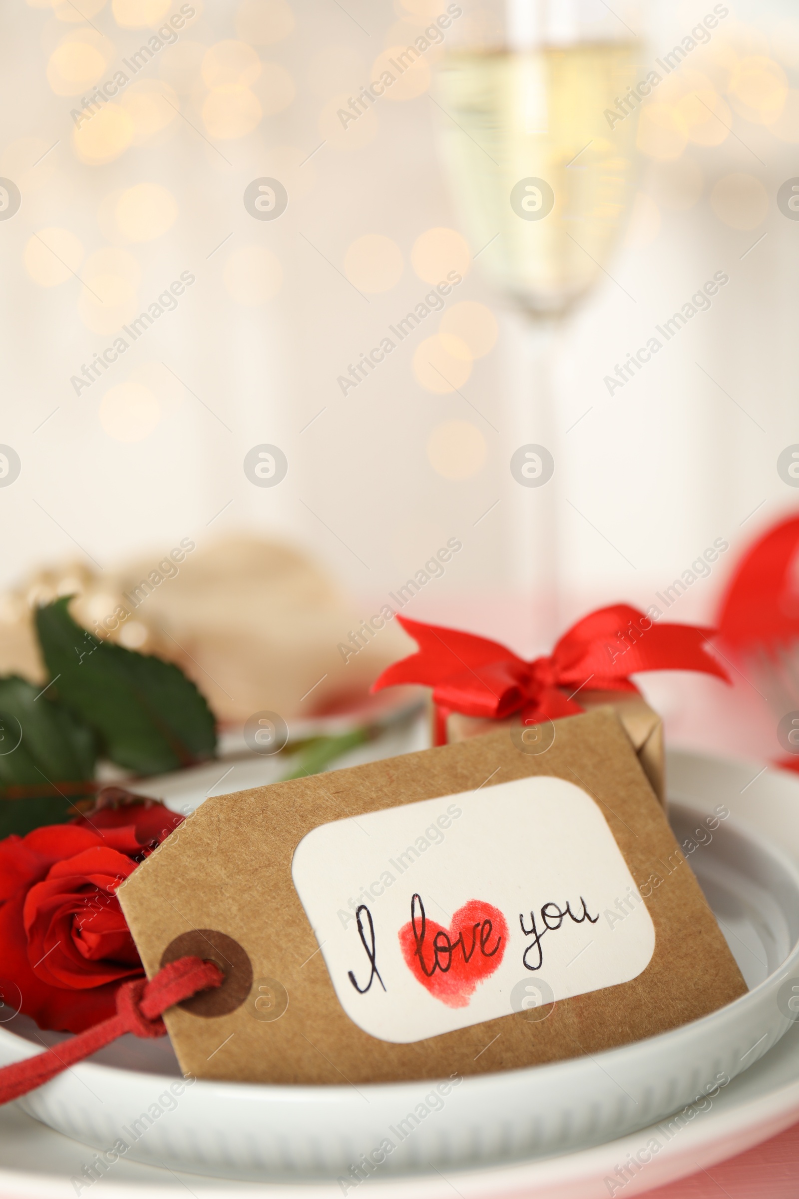 Photo of Elegant place setting for romantic dinner on table, closeup. Valentine's day celebration