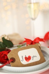 Photo of Elegant place setting for romantic dinner on table, closeup. Valentine's day celebration