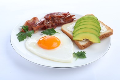 Photo of Romantic breakfast with fried bacon, heart shaped egg and avocado toast isolated on white. Valentine's day celebration