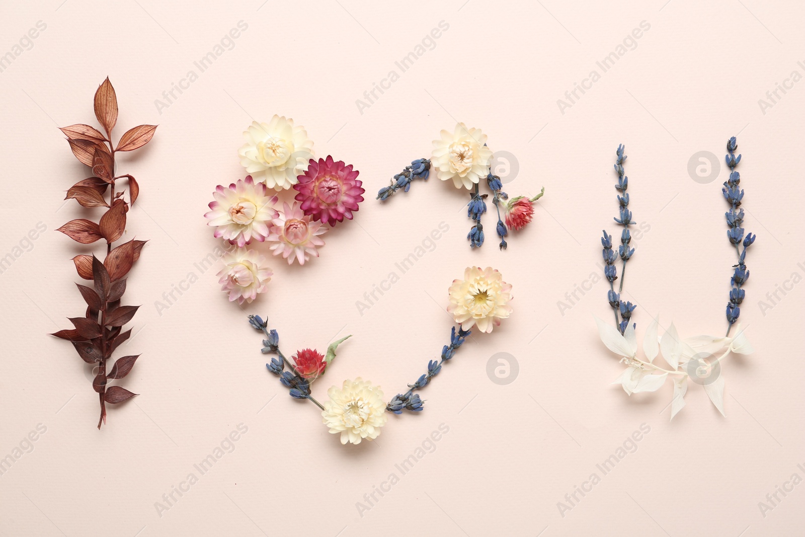 Photo of Phrase I Love You made of flowers on beige background, flat lay