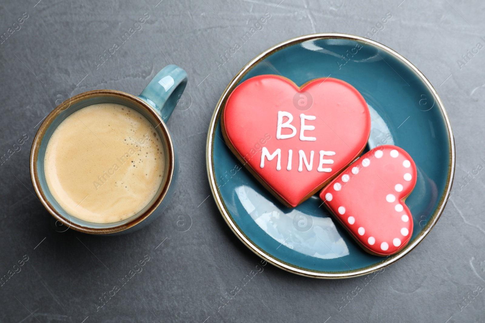 Photo of Cup of coffee and heart shaped cookies on grey table, flat lay. Valentine's day breakfast