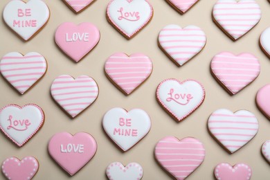 Photo of Delicious heart shaped cookies on beige background, flat lay. Valentine's Day