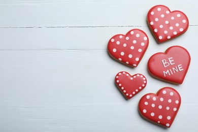 Photo of Delicious heart shaped cookies on white wooden table, flat lay with space for text. Valentine's Day