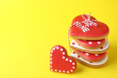 Photo of Gift set of heart shaped cookies on yellow background, closeup with space for text. Valentine's day treat