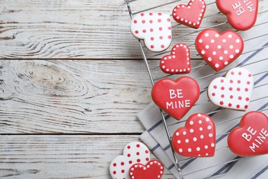 Photo of Heart shaped cookies on white wooden table, flat lay with space for text. Valentine's day treat