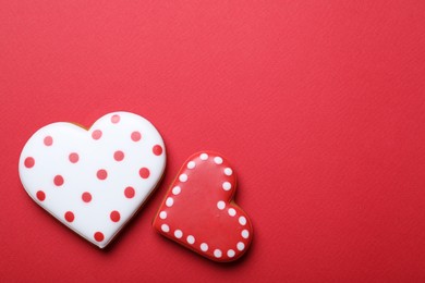 Photo of Valentine's day cookies on red background, flat lay. Space for text