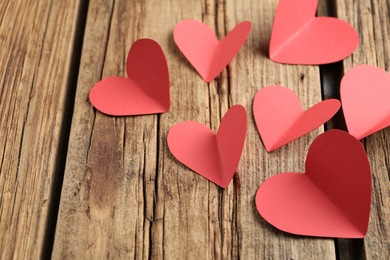 Photo of Red paper hearts on wooden table. St. Valentine's day