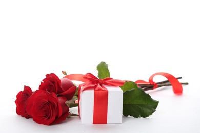 Photo of Beautiful red roses and gift box on white background. St. Valentine's day celebration