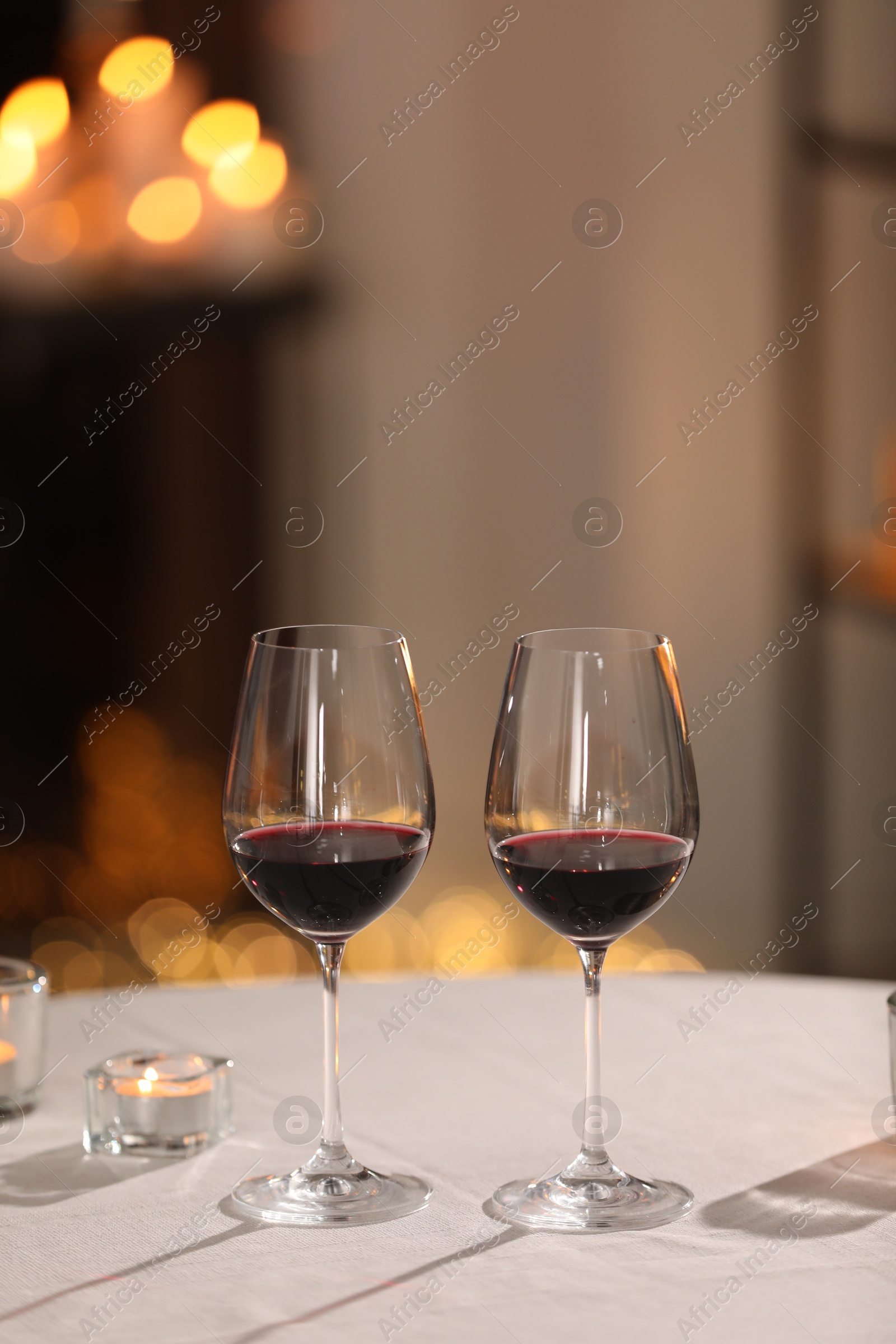 Photo of Glasses of wine for romantic dinner on table in restaurant