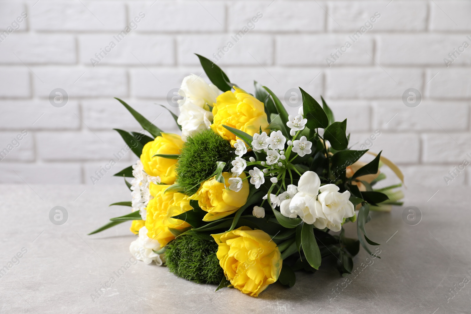 Photo of Beautiful bouquet with peony tulips on light table