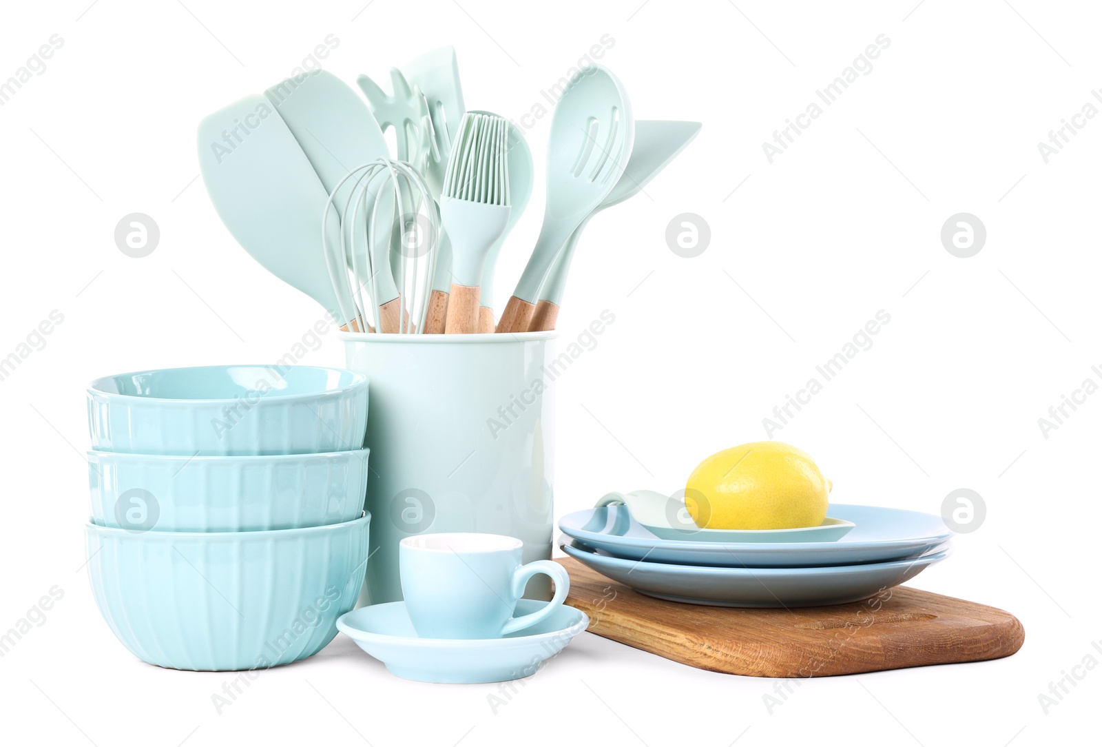 Photo of Different cooking utensils and lemon isolated on white