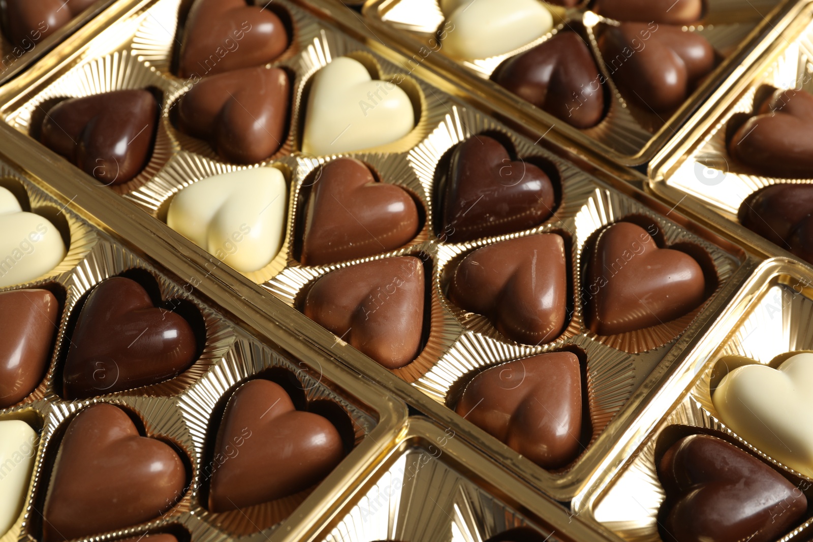 Photo of Beautiful heart shaped chocolate candies in box as background